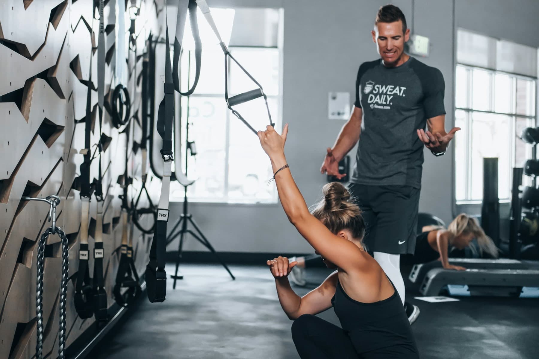 Trainer guiding a resistance exercise